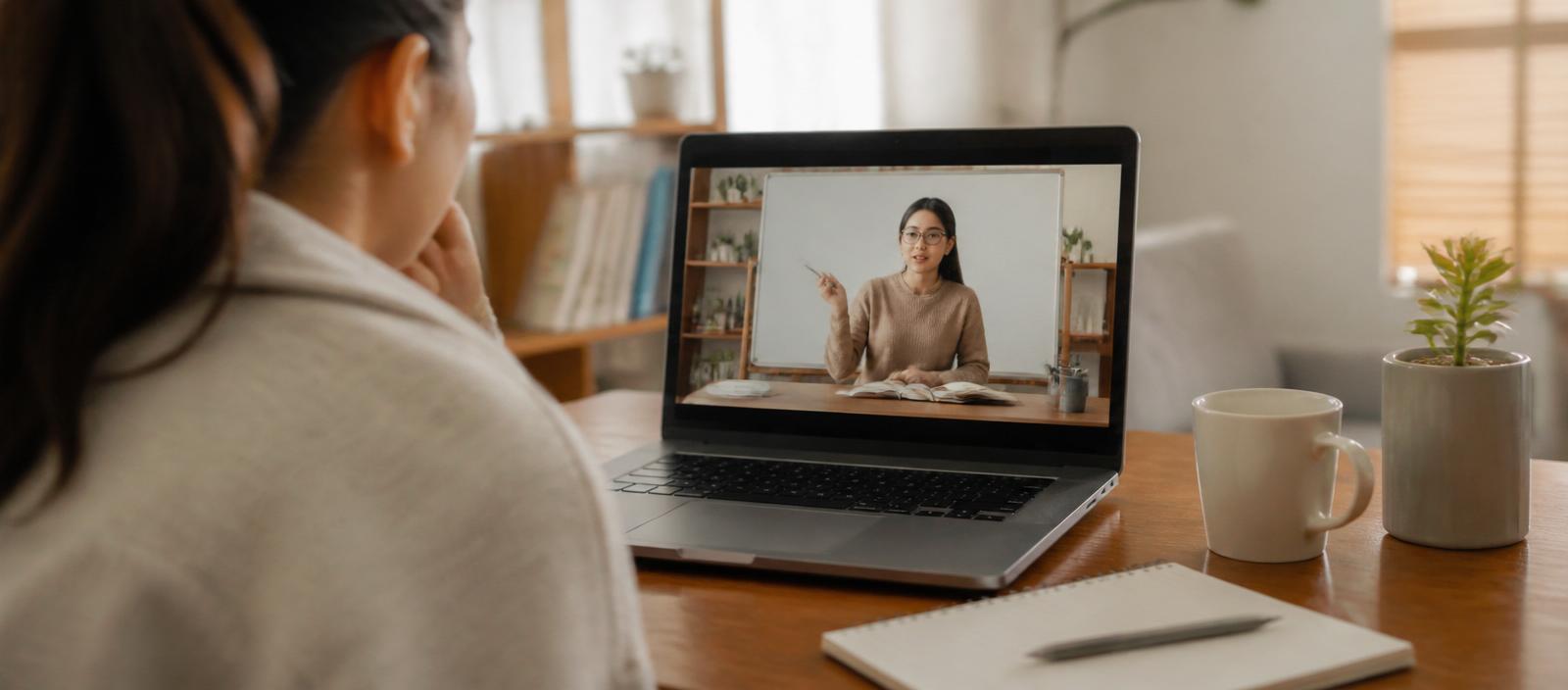 Person watching an educational video on a laptop